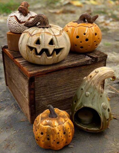 Decorative ceramic pumpkins on a wooden box with a natural outdoor background